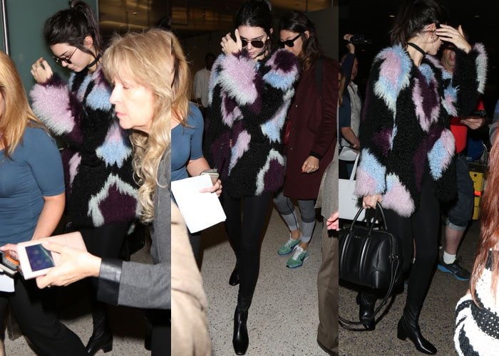 Kendall Jenner wears an Elizabeth and James jacket as she arrives at LAX