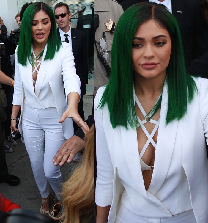 Kylie Jenner shows off a new green hairstyle at the launch of her lip kit collection