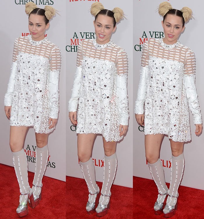 Miley Cyrus poses in a Prada ensemble on the red carpet of a Netflix premiere