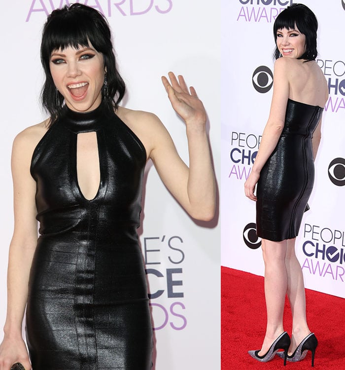 Carly Rae Jepsen smiles and waves in a gothic vampy look on the red carpet of the People's Choice Awards