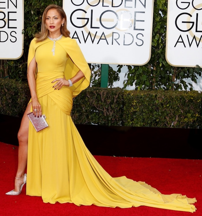 Jennifer Lopez shows off the train on her yellow Giambattista Valli dress