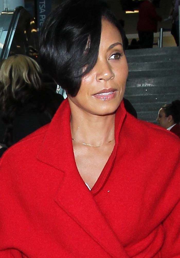 Jada Pinkett-Smith wears her hair down as she arrives at Los Angeles International Airport