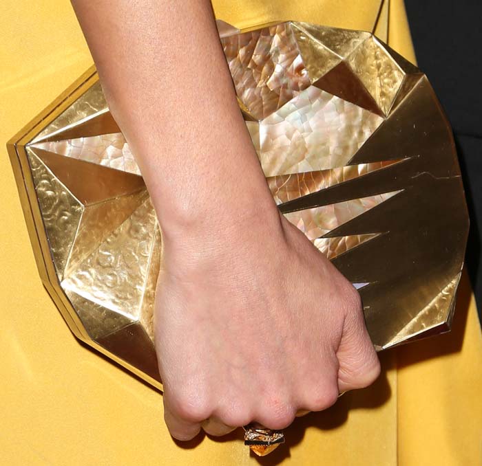 Jamie Chung complements her look with a unique geometric clutch by Emm Kuo