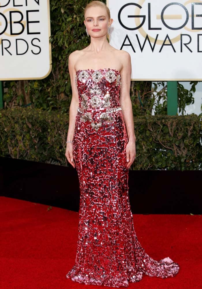 Kate Bosworth dazzles on the Golden Globes red carpet in a shimmering, strapless Dolce & Gabbana gown adorned with intricate sequins and jewels, making a statement of elegance and glamour