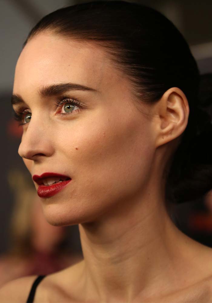 Rooney Mara wears simple eye makeup and dark lipstick on the AACTA red carpet