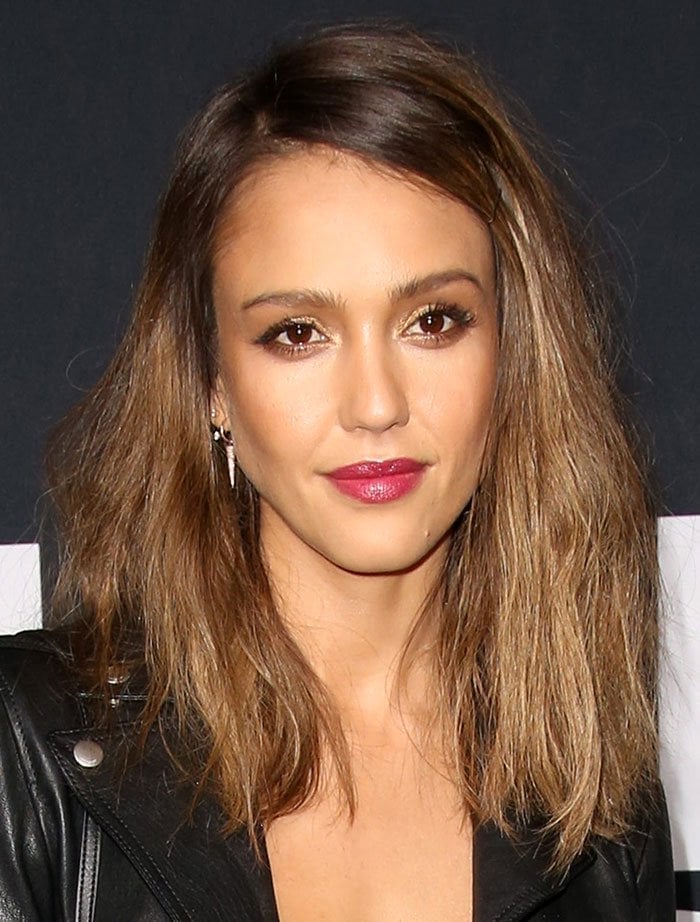 Jessica Alba wears berry-colored lipstick and shimmering eye makeup to the debut of Saint Laurent's latest collection