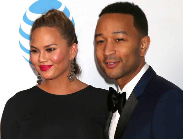 Chrissy Teigen and John Legend pose for photos on the red carpet of the NAACP Image Awards