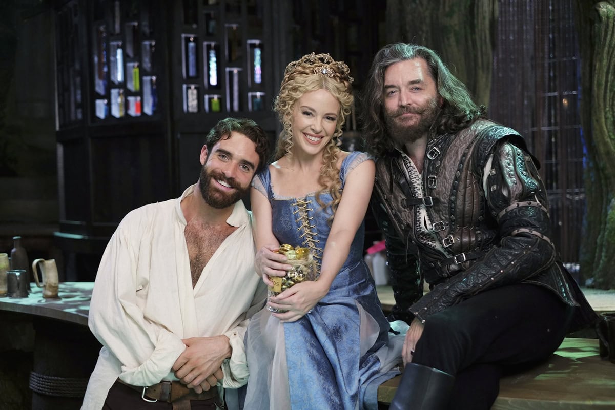 Timothy Omundson as King Richard, Kylie Minogue, and Joshua Sasse on the set of Galavant, where Kylie and Joshua’s on-screen chemistry blossomed into a real-life romance