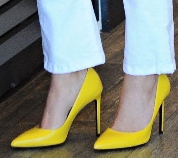 Reese Witherspoon's feet in bright yellow Saint Laurent heels