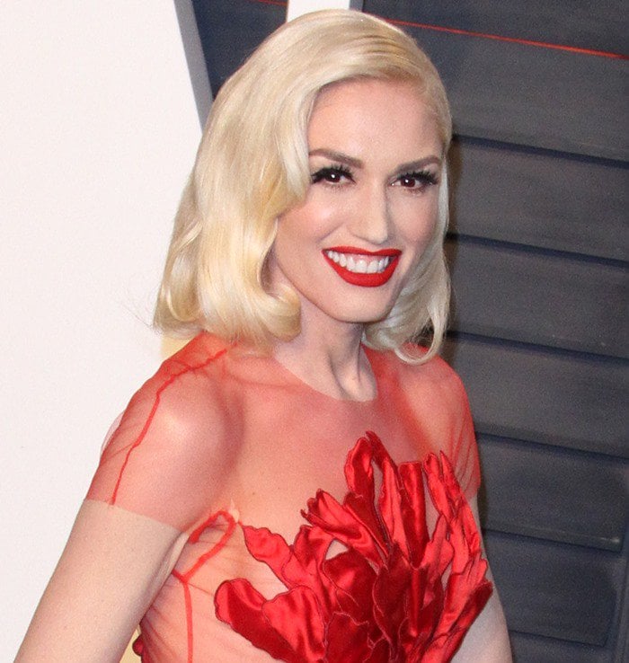 Gwen Stefani donned a red sheer gown from the Yanina Spring 2015 Couture Collection featuring applique petals