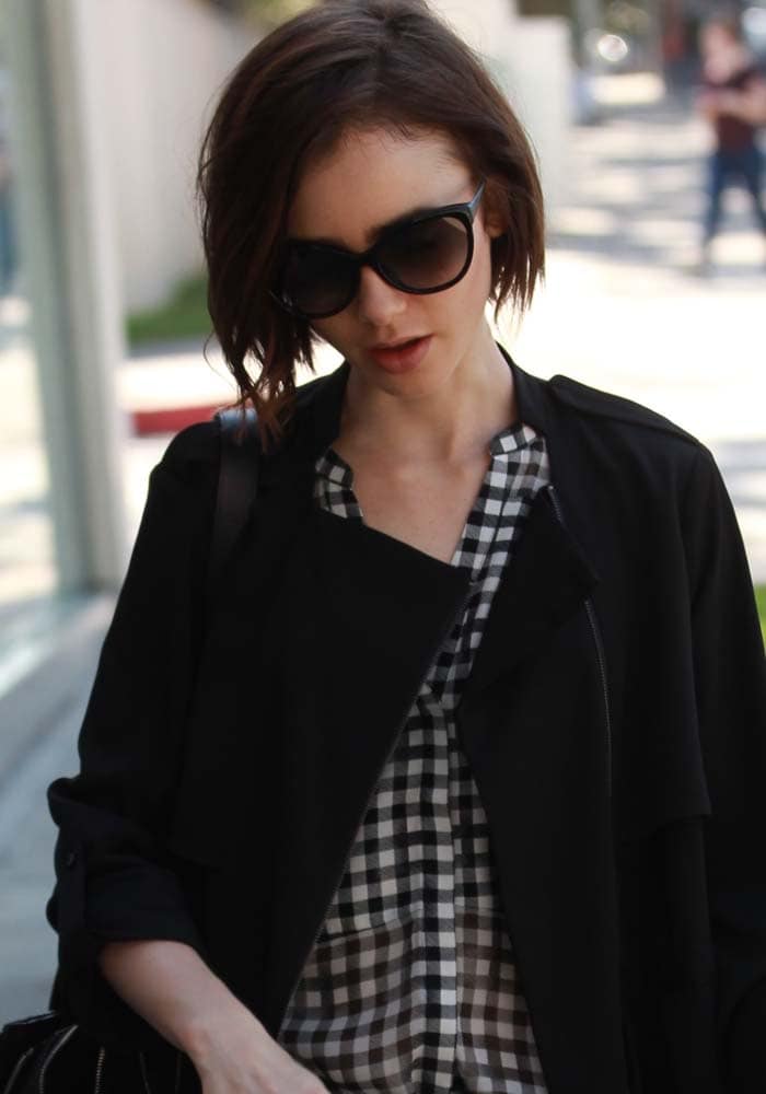 Lily Collins hides behind her hair while out in Beverly Hills