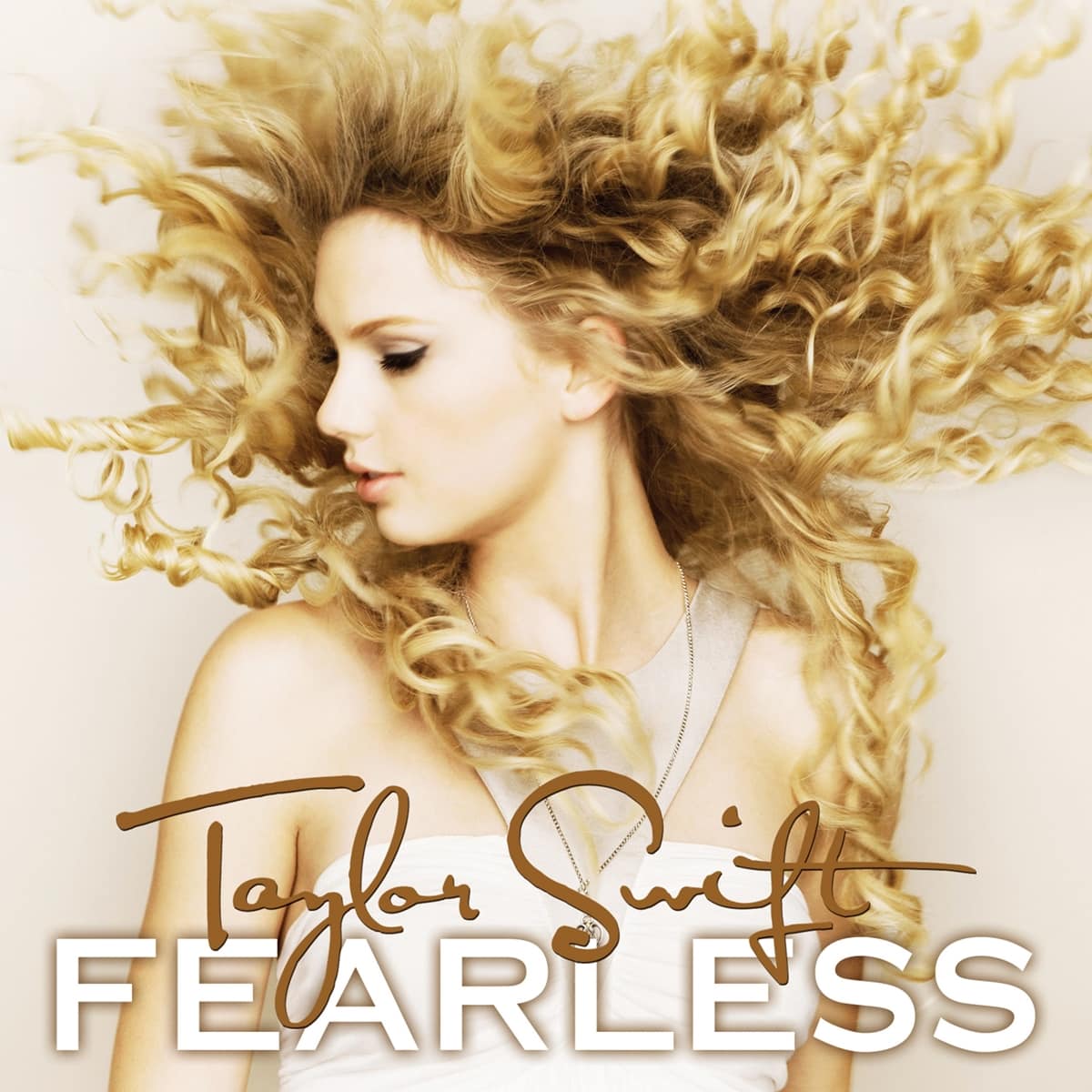 Taylor Swift's iconic Fearless album cover captures her signature curls in motion, reflecting the album's theme of youthful energy and boldness