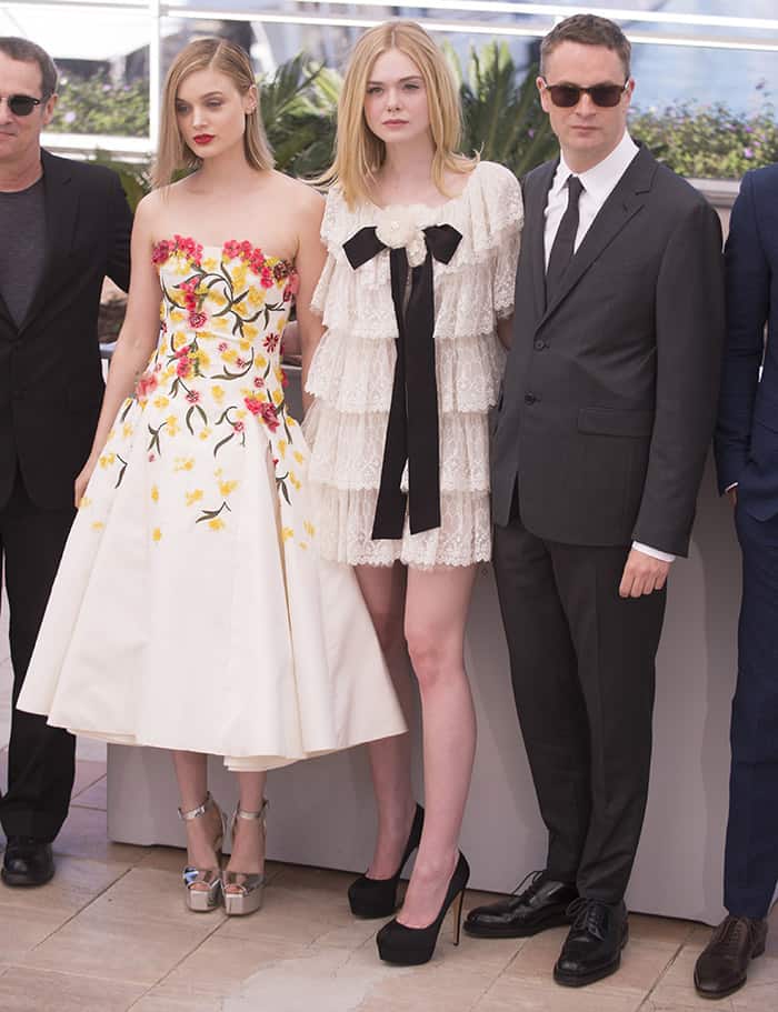 Elle Fanning and Bella Heathcote pose with director Nicolas Winding Refn at the 69th Cannes Film Festival