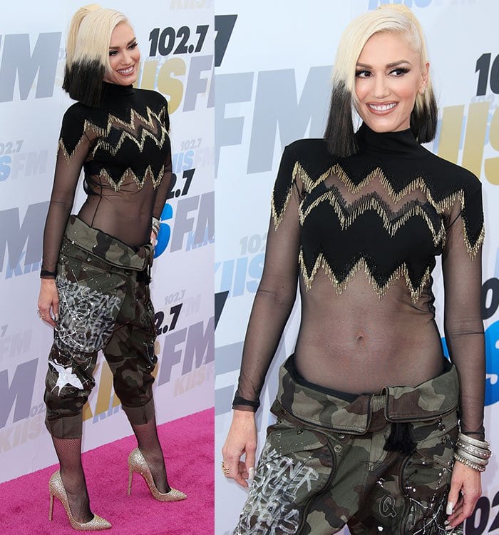 Gwen Stefani wears a sheer glittery bodysuit under a pair of paint-splattered cargo pants and fishnet tights