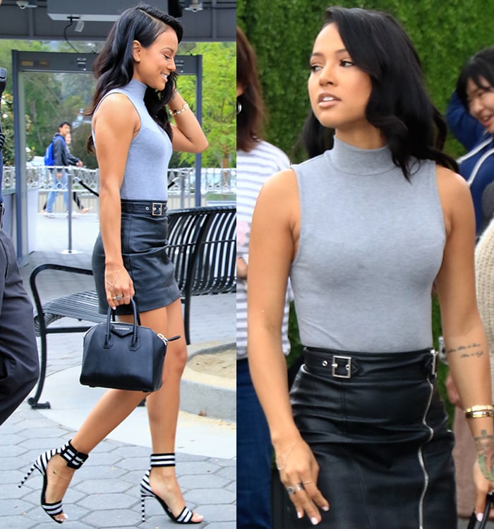 Karrueche Tran turned heads in a sleeveless gray top with a high neck and a black leather mini skirt