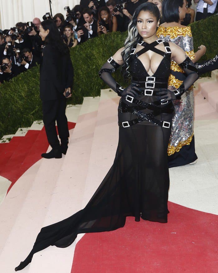 Nicki Minaj's massive cleavage almost spilled out of her bondage-inspired black gown