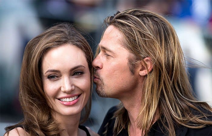 Brad Pitt giving Angelina Jolie a kiss at the premiere of World War Z at Empire Leicester Square in London, England, on June 2, 2013