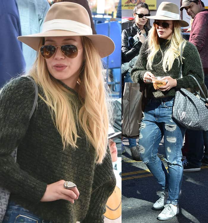 Hilary Duff is carrying a large brown shopping tote and a smaller Goyard bag while holding a snack in her hand