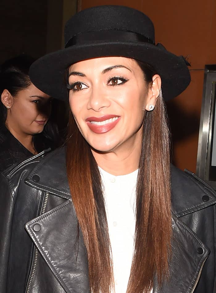 Nicole Scherzinger flashes a bright smile in her edgy leather jacket and black hat as she leaves Zuma restaurant after the Dreamgirls press night in London