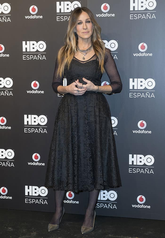 Sarah Jessica Parker accessorized her black lace midi dress with a statement layered necklace, diamond stud earrings, and several rings