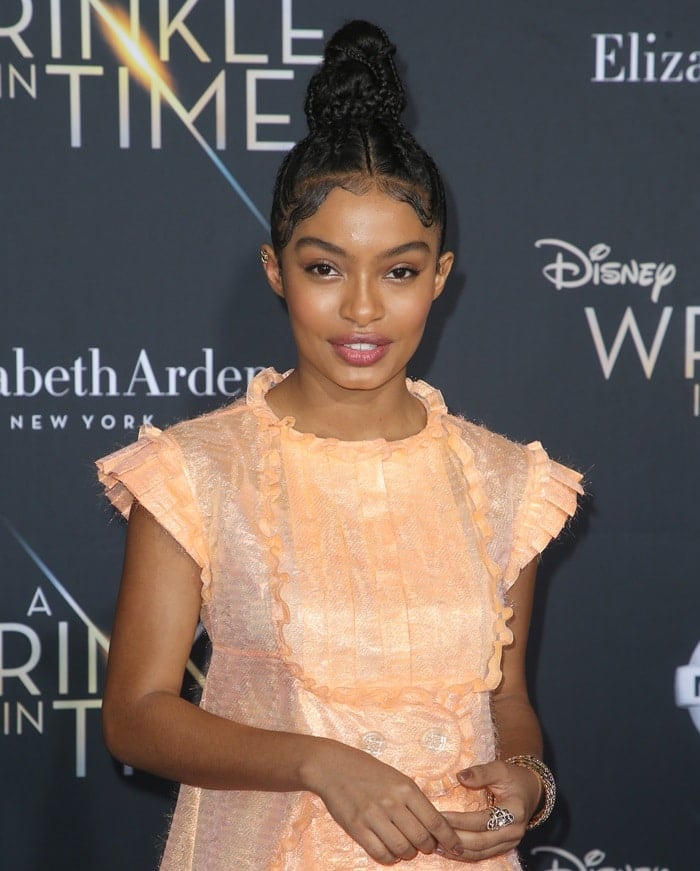 Yara Shahidi radiates in a soft peach Chanel dress, styled with a sleek braided updo and glowing makeup, at the A Wrinkle in Time premiere