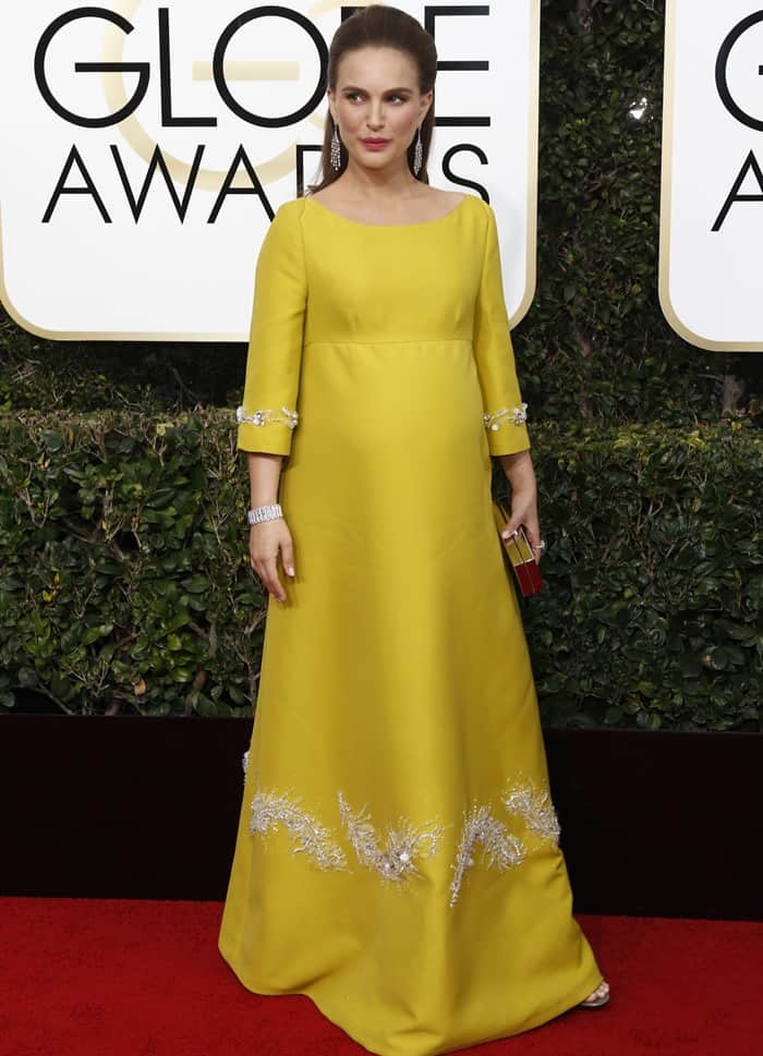 Natalie Portman radiates elegance in a vintage-inspired canary yellow Prada gown adorned with delicate silver embroidery