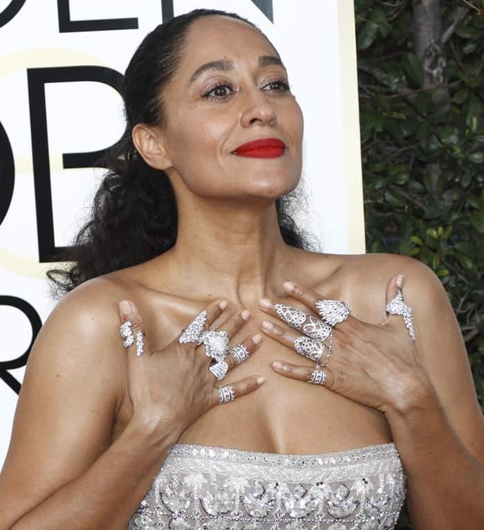 Tracee Ellis Ross pairs her elegant updo and bold red lip with a striking array of diamond rings