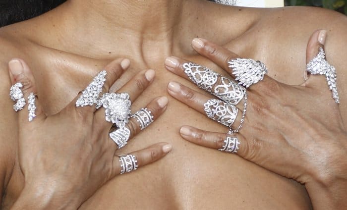 Tracee Ellis Ross showcases an intricate collection of diamond rings on each finger perfectly complemented by her nude manicure