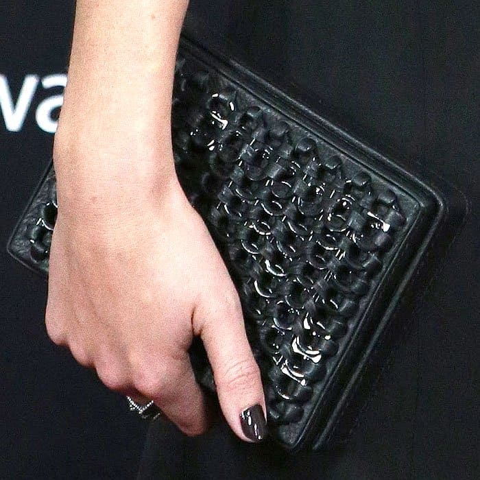 Detail of Emma Watson's custom Bottletop clutch crafted from zero-deforestation leather and embellished with metal soda can tabs.