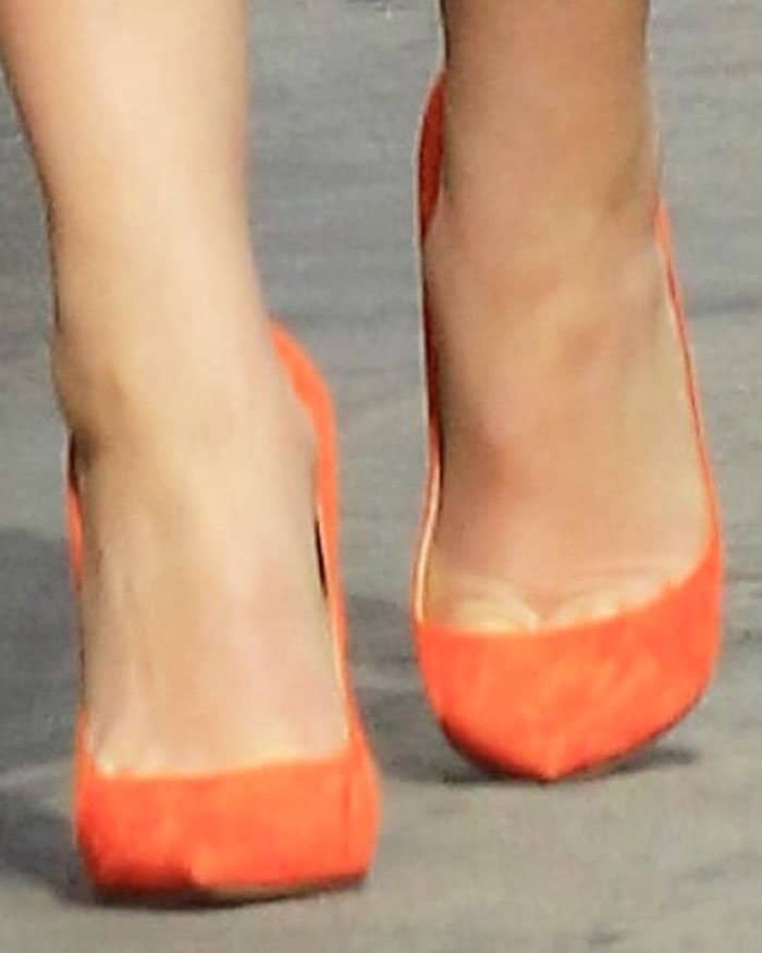 Katherine Heigl adds a pop of orange into her look with a pair of Christian Louboutin So Kate pumps