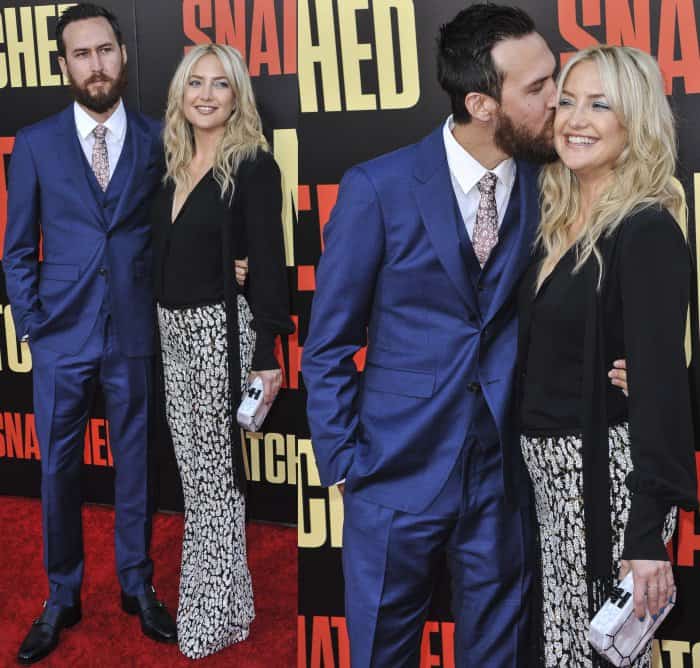 Danny Fujikawa in a navy blue suit and Kate Hudson in a custom look from Michael Kors Collection and Giuseppe Zanotti embellished platform sandals at the LA premiere of "Snatched"