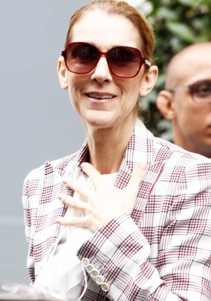 Celine Dion departs from Le Royal Monceau hotel in Paris on July 20, 2017, radiating effortless style in a chic plaid blazer and oversized sunglasses