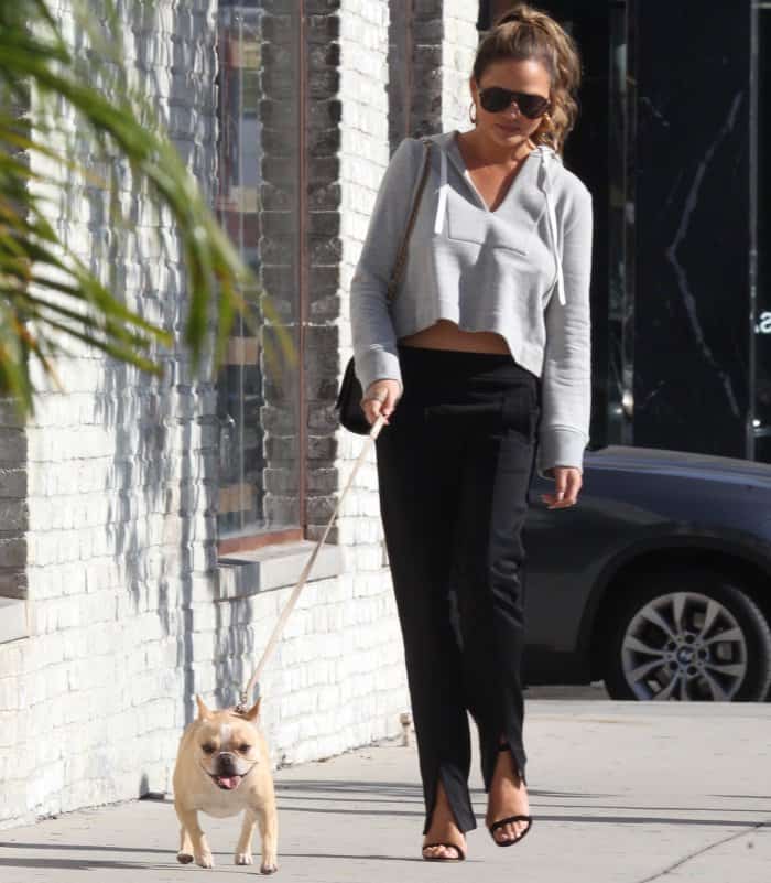 Chrissy Teigen wearing an A.L.C. ensemble and black ankle-strap sandals with clear heels while out and about in LA