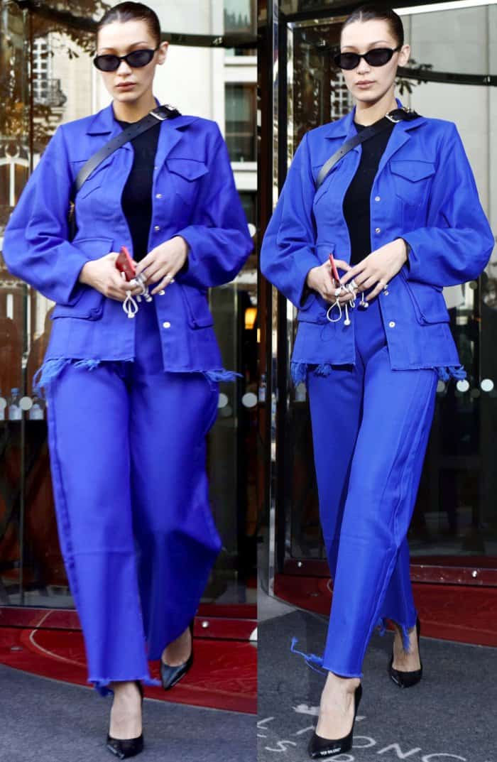 Bella Hadid wearing a blue Marques’Almeida structured jacket, matching wide-legged pants, and Off-White "For Walking" black leather pumps while leaving her hotel in Paris