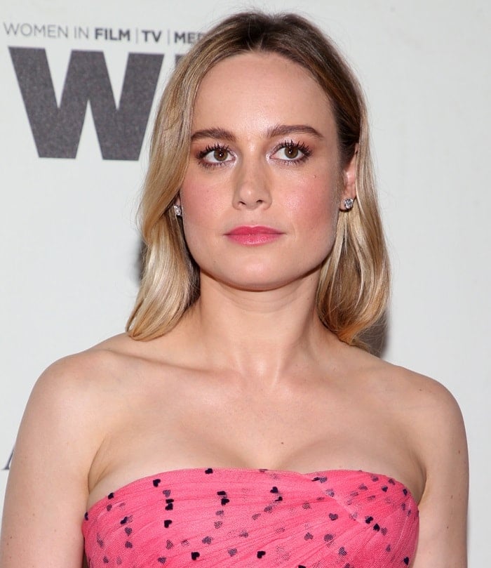 Brie Larson paired her soft pink lips and delicate Fred Leighton jewelry with sleek, shoulder-length waves, complementing her vibrant pink Carolina Herrera strapless dress at the Women in Film Crystal + Lucy Awards