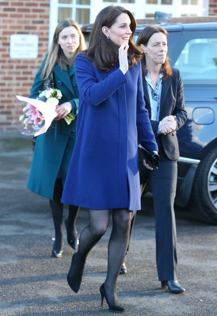 Catherine, Duchess Of Cambridge (aka Kate Middleton) greeted her fans in a blue Goat coat styled with a limited edition 'Blue Heart' clutch in black croc and her favorite 'Power' pumps from Stuart Weitzman