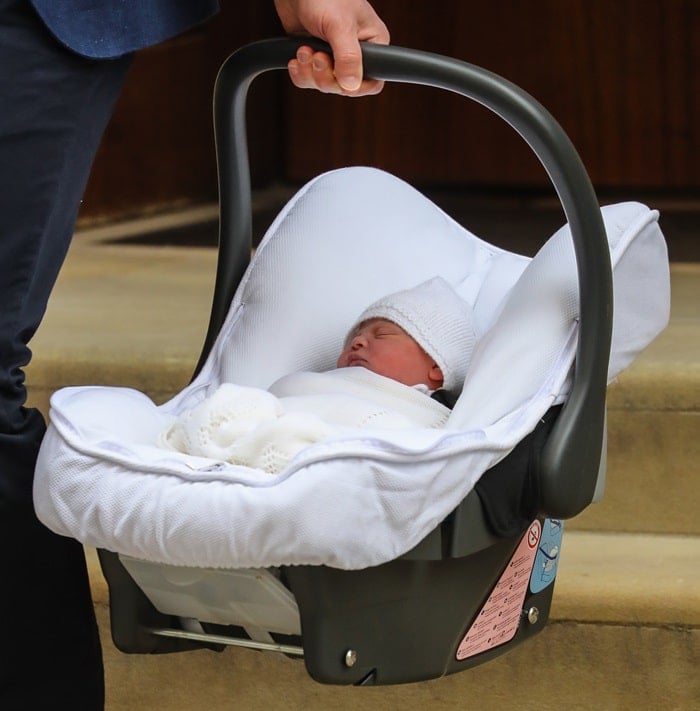 Prince William carrying his newborn son