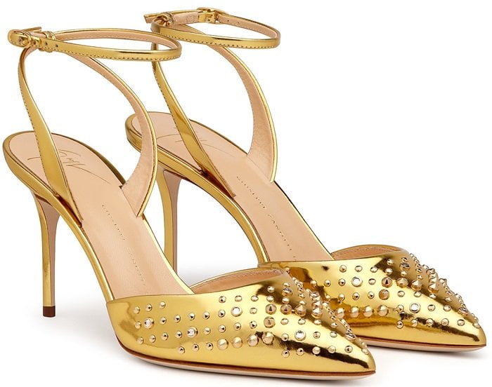 The mirrored golden leather is studded across the pointed toes, with low-slung uppers and a heel-fastening strap creating a streamlined silhouette