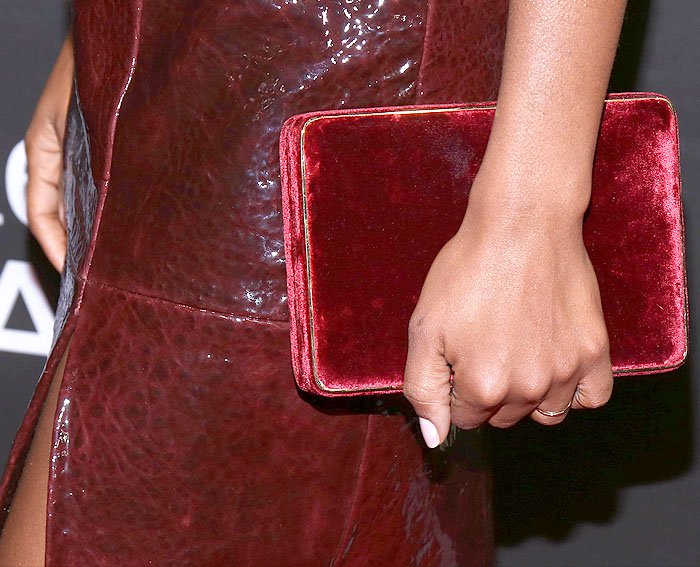 Details of Kerry Washington's gold-trimmed red velvet box clutch.