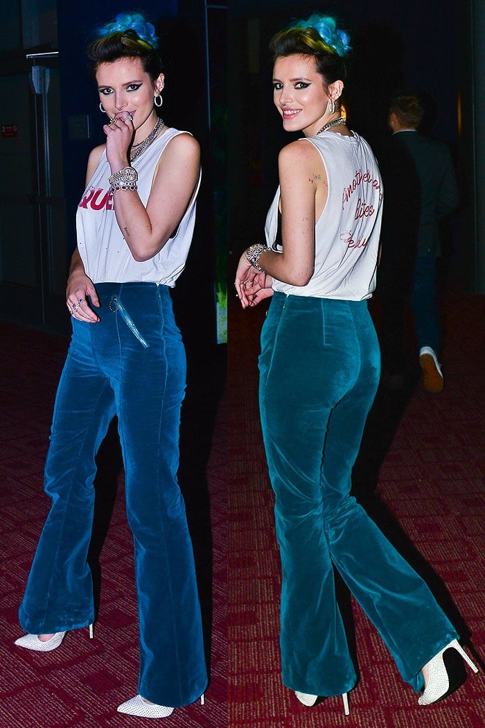 Bella Thorne in a Queen cutoff tee, blue-green flare pants, and studded white Saint Laurent 'Paris' pumps