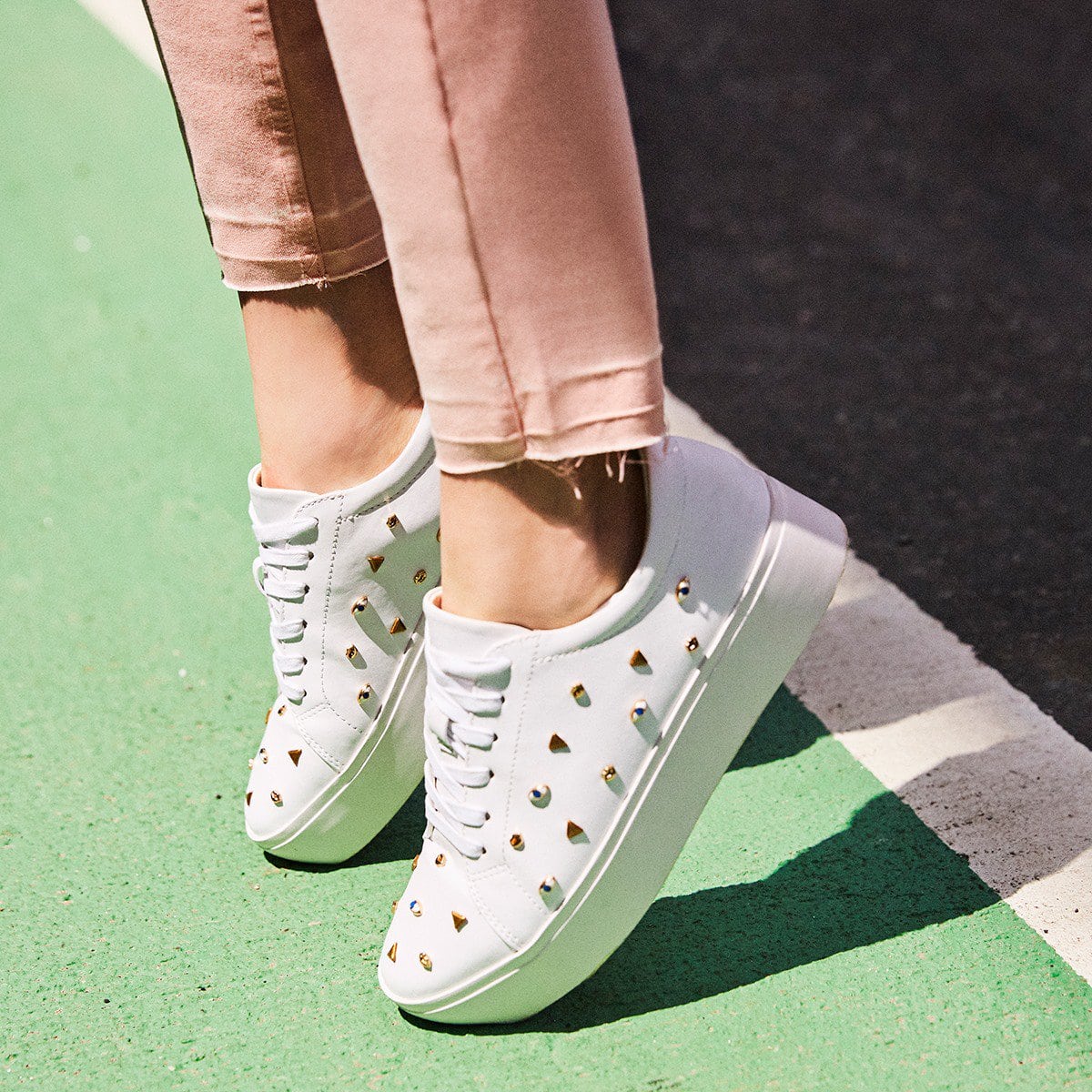 These platform sneakers in smooth Nappa leather boast cute decorations like all-seeing eyes, lips, and gilded shapes