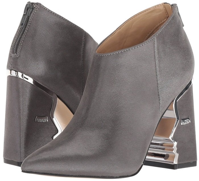 Heeled ankle boots with suede upper featuring face silhouette and hardware detailing