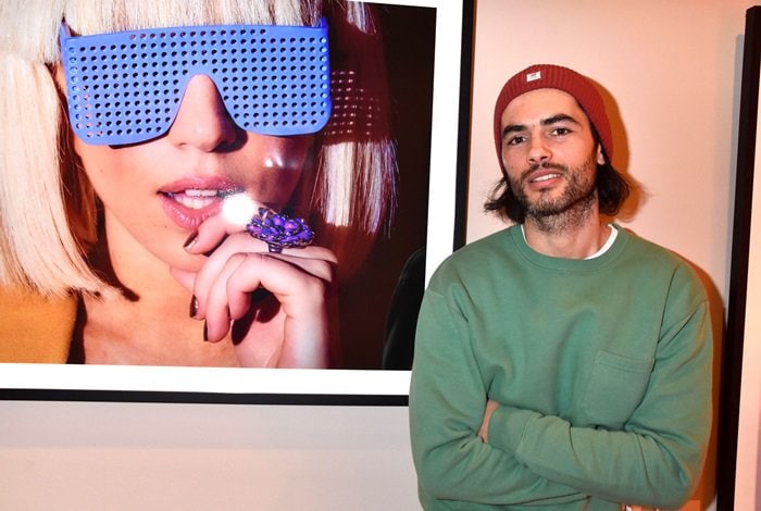 Nik Xhelilaj, an Albanian film and stage actor, posing in front of a picture of Lady Gaga at the vernissage Jens Koch at Hotel de Rome in Berlin on January 31, 2019