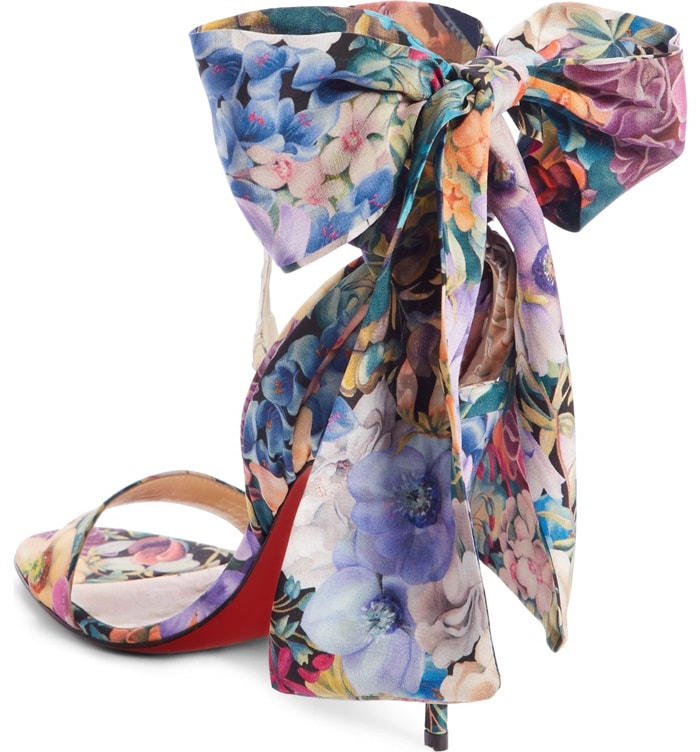 Romantic blooms enliven an elegant sandal crafted from luxurious silk with wide, scarflike straps that wrap around and tie at the ankle