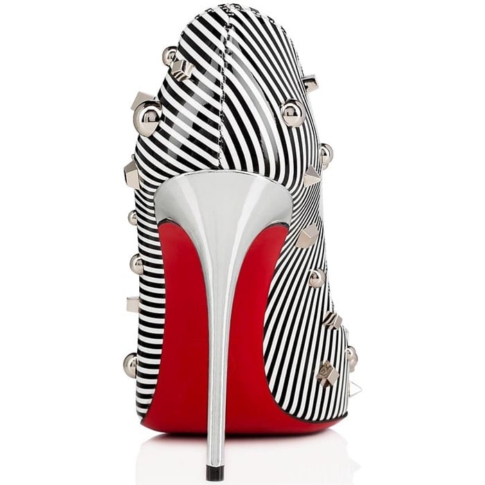 Mounted on a 100mm silver specchio stiletto heel, the pointed-toe model, covered in black and white striped patent leather and an array of studs, offers a subtly low-cut décolleté