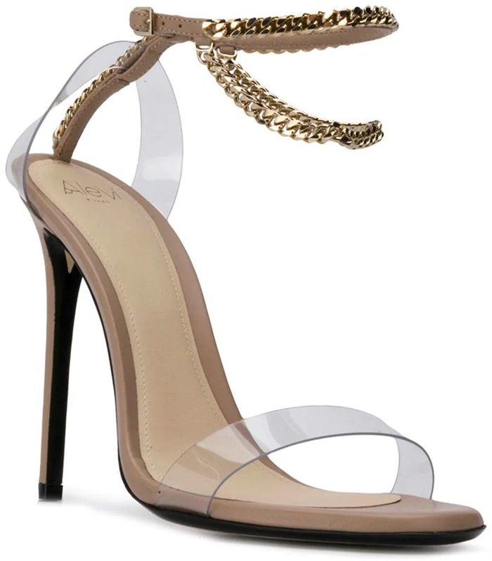 Nude leather sandals featuring an open toe, a high heel, an ankle strap, a chain link strap, and gold-tone hardware