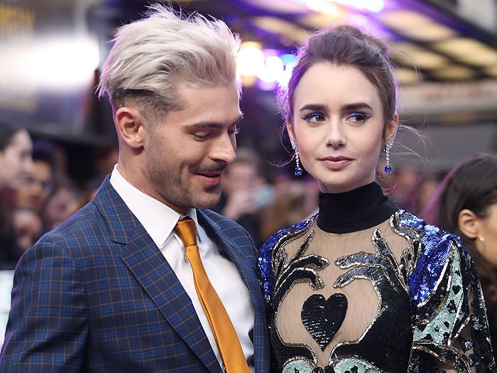 Zac Efron stealing a glance at Lily Collins and her exquisite dress