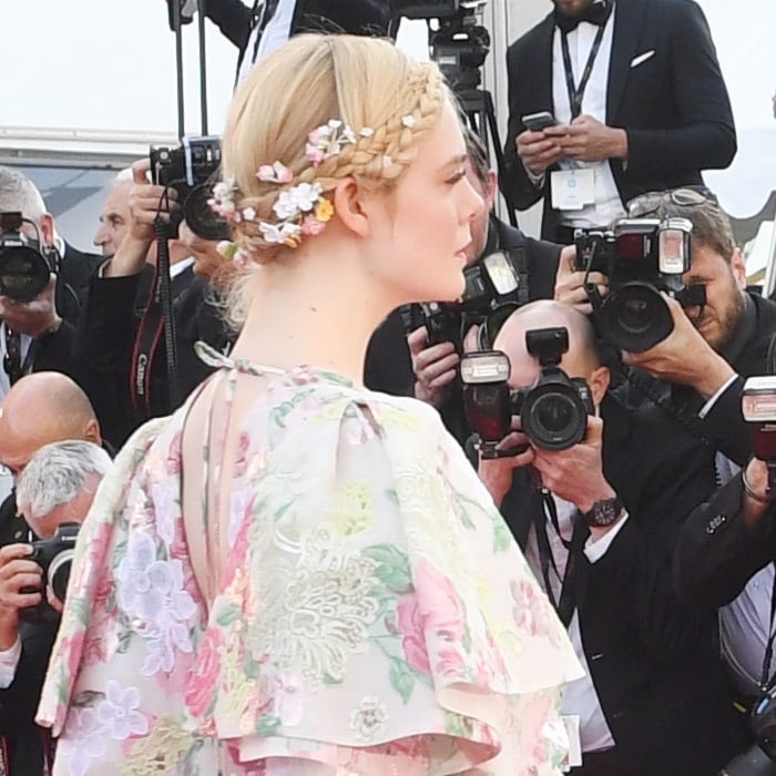 Elle Fanning accessorized her milkmaid braids with tiny daisies, roses, and white flowers