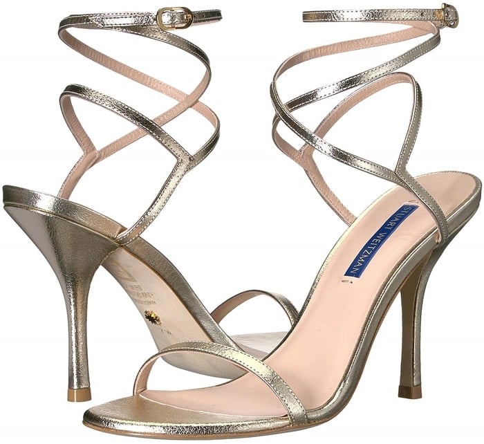 Accentuate your evening look in the Merinda sandals featuring a metallic or patent leather and a wraparound ankle strap