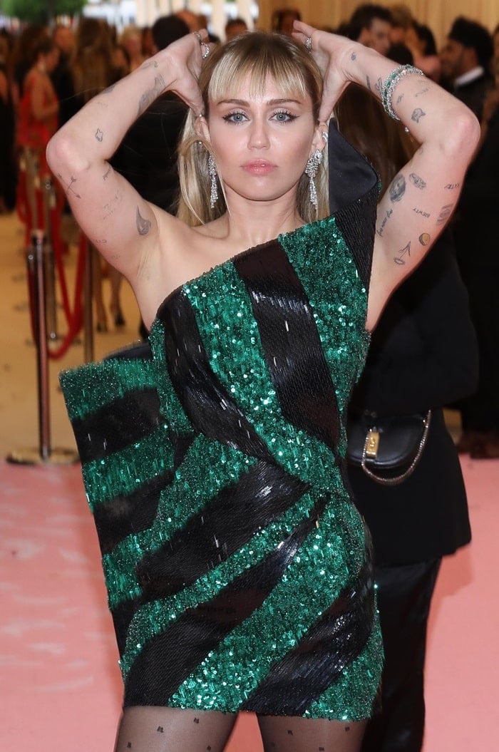 Miley Cyrus donned a one-shouldered black and green mini dress